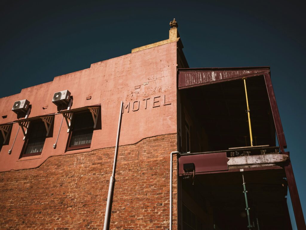 Vintage-style motel with air conditioners on the facade, exuding a nostalgic atmosphere.